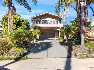 a house with palm trees and a driveway at Ocean-View Mountaintop Getaway. Jacuzzi/Ping-Pong! in San Diego