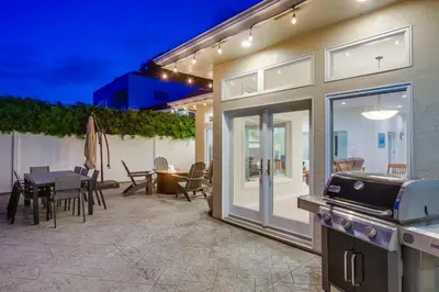 a house with a patio with a table and a grill at Point Loma Serenity in San Diego