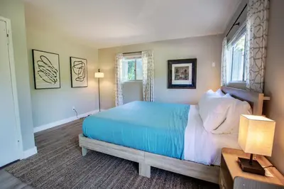 a bedroom with a blue bed and a window at Cozy Getaway. Fire Pit and Endless Views! 5 Beds in San Diego