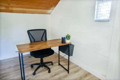 a desk with a chair in a room at Cozy Getaway. Fire Pit and Endless Views! 5 Beds in San Diego
