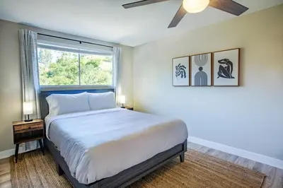 a bedroom with a large bed and a window at Cozy Getaway. Fire Pit and Endless Views! 5 Beds in San Diego