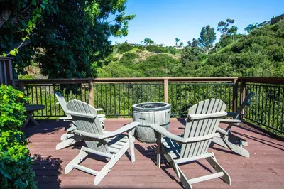 three chairs and a trash can on a deck at Cozy Getaway. Fire Pit and Endless Views! 5 Beds in San Diego