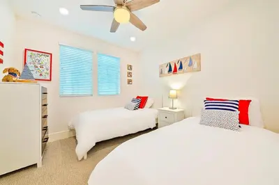 a bedroom with two beds and a ceiling fan at Bayside Cove 5 in San Diego