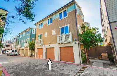 a building with two garage doors and a arrow pointing to it at Bayside Cove 5 in San Diego