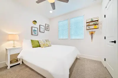 a white bedroom with a bed and a window at Bayside Cove 5 in San Diego
