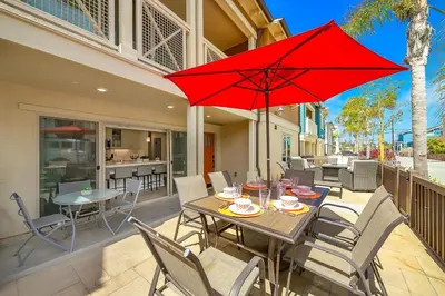 a table and chairs with a red umbrella on a patio at Bayside Cove 5 in San Diego