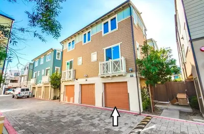 a building with two garage doors on a street at Bayside Cove 4 in San Diego