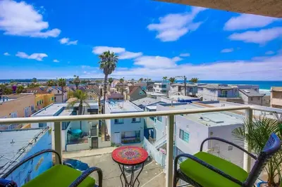 a balcony with chairs and a view of a city at Penthouse in San Diego