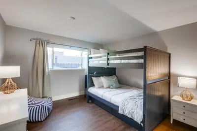 a bedroom with a bunk bed and a window at Tropical Retreat in San Diego