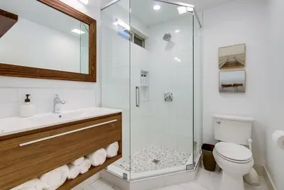 a bathroom with a shower and a toilet and a sink at Tropical Retreat in San Diego