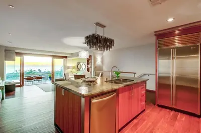 a kitchen with red cabinets and a counter top at Seaside in Cardiff-by-the-Sea