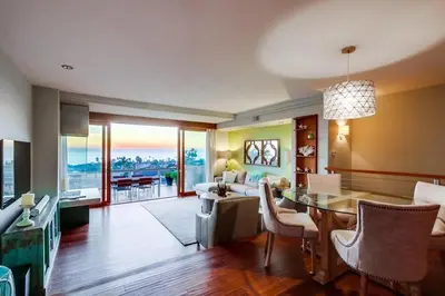 a living room with a table and a dining room at Seaside in Cardiff-by-the-Sea