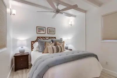 a bedroom with a bed with a ceiling fan at Jetty View 1 in San Diego