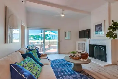 a living room with a couch and a fireplace at Jetty View 1 in San Diego