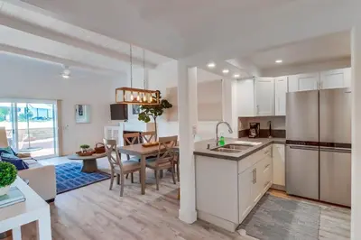 a kitchen and living room with a table and a dining room at Jetty View 1 in San Diego