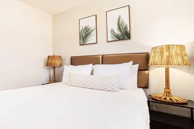 a bedroom with a large bed with two lamps at Boutique Charm 3BR w/ Huge Deck in Bonita