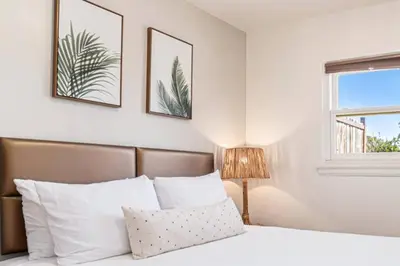 a bedroom with a bed and two pictures on the wall at Boutique Charm 3BR w/ Huge Deck in Bonita