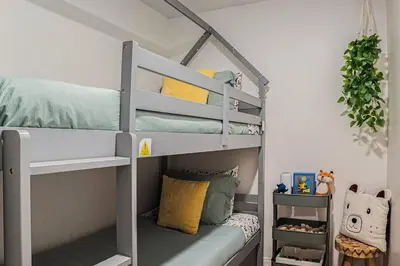 a bunk bed in a room with a bunk bedutenewayewayangering at Boutique Charm 3BR w/ Huge Deck in Bonita