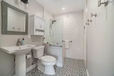 a white bathroom with a toilet and a sink at One bedroom retreat full kitchen/laundry 1GB Wi-Fi in Bonita