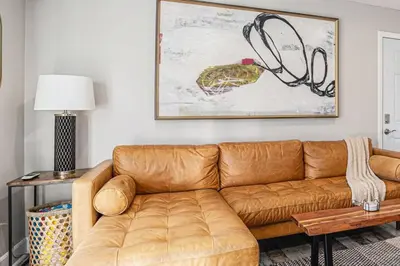 a living room with a brown leather couch at One bedroom retreat full kitchen/laundry 1GB Wi-Fi in Bonita