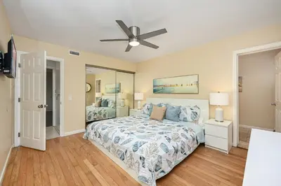 a bedroom with a bed and a ceiling fan at 4 bedroom home with Patio 10 seconds from the Sand in Newport Beach