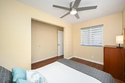 a bedroom with a bed and a ceiling fan at 4 bedroom home with Patio 10 seconds from the Sand in Newport Beach