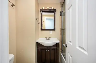 a bathroom with a sink and a mirror at 4 bedroom home with Patio 10 seconds from the Sand in Newport Beach