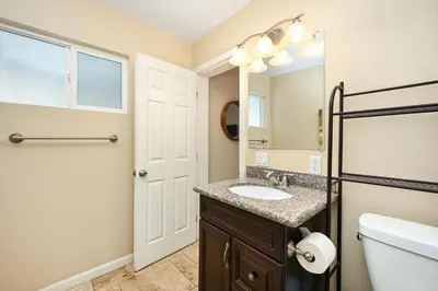 a bathroom with a sink and a mirror at 4 bedroom home with Patio 10 seconds from the Sand in Newport Beach