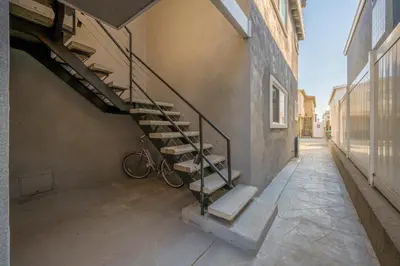 a staircase in the side of a building with a bike at 4 bedroom home with Patio 10 seconds from the Sand in Newport Beach