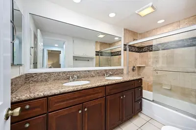 a bathroom with two sinks and a large mirror at 4 bedroom home with Patio 10 seconds from the Sand in Newport Beach