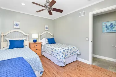 a bedroom with two beds and a ceiling fan at 4 Bedroom Home Steps from the Sand with Balcony & BBQ in Newport Beach