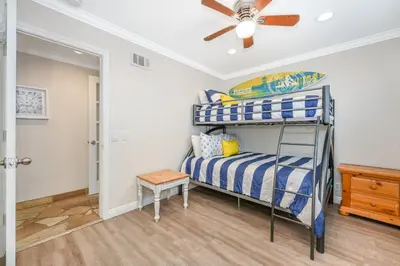 a bedroom with a bunk bed and a ceiling fan at Giant 7 Bedroom Home with 3 separate Condos in Newport Beach