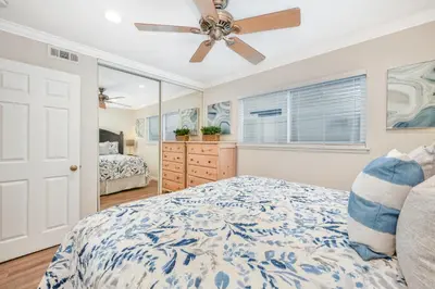 a bedroom with a bed and a ceiling fan at Giant 7 Bedroom Home with 3 separate Condos in Newport Beach