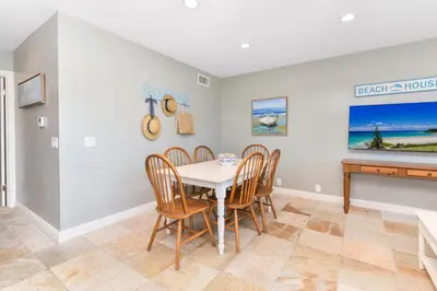 a dining room with a table and chairs at Giant 7 Bedroom Home with 3 separate Condos in Newport Beach