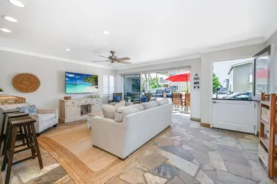a living room with a couch and a table at Giant 7 Bedroom Home with 3 separate Condos in Newport Beach