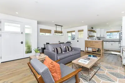 a living room with a couch and a table at BRAND NEW Luxury 1 Bedroom Condo Steps from the Beach in Newport Beach