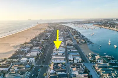 an aerial view of a beach with a yellow arrow at BRAND NEW Luxury 1 Bedroom Condo Steps from the Beach in Newport Beach