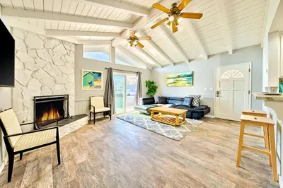 a living room with a couch and a fireplace at 6 Bedroom Home with Rooftop Deck Between the Bay & the Beach in Newport Beach