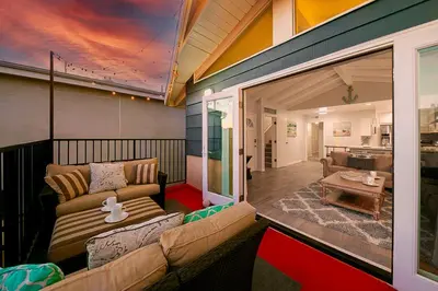 a living room with a couch and a table at 2 Story Home with Rooftop Deck next to the Bay & Beach in Newport Beach