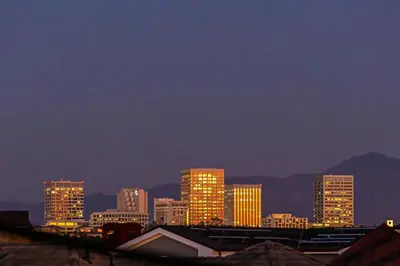 a city skyline with tall buildings at night at 2 Story Home with Rooftop Deck next to the Bay & Beach in Newport Beach