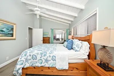 a bedroom with a bed and a ceiling fan at Oceanfront Home with UNOBSTRUCTED VIEW in Newport Beach
