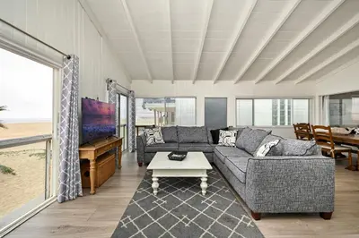 a living room with a couch and a table at Oceanfront Home with UNOBSTRUCTED VIEW in Newport Beach