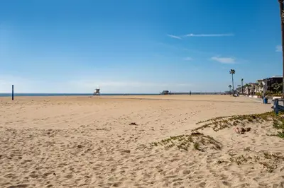a sandy beach with footprints in the sand at Oceanfront Home with UNOBSTRUCTED VIEW in Newport Beach