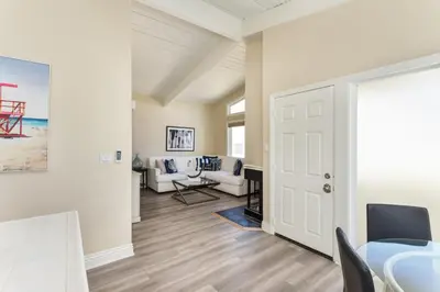 a living room with white walls and a white door at 2 Bedroom in BACK of our BEACHFRONT Home in Newport Beach
