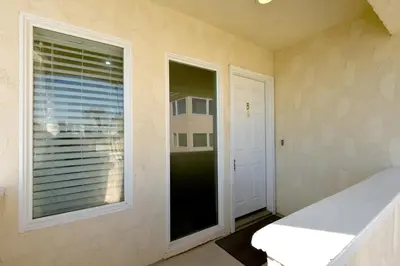 a room with a large window and a door at 2 Bedroom in BACK of our BEACHFRONT Home in Newport Beach