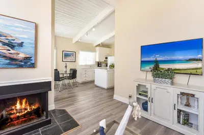 a living room with a fireplace and a flat screen tv at 2 Bedroom in BACK of our BEACHFRONT Home in Newport Beach