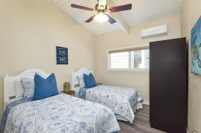 a bedroom with two beds and a ceiling fan at 2 Bedroom in BACK of our BEACHFRONT Home in Newport Beach