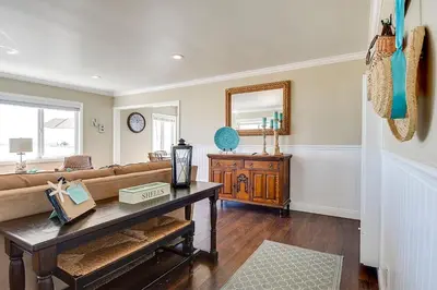 a living room with a couch and a table at Beachfront Getaway on the Sand in Newport Beach