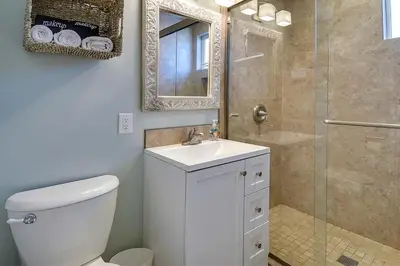 a bathroom with a toilet and a sink and a shower at Beachfront Getaway on the Sand in Newport Beach