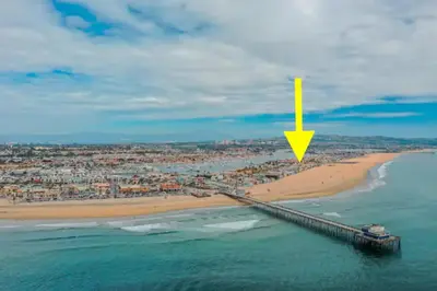 an aerial view of a beach with a pier at Beachfront Getaway on the Sand in Newport Beach